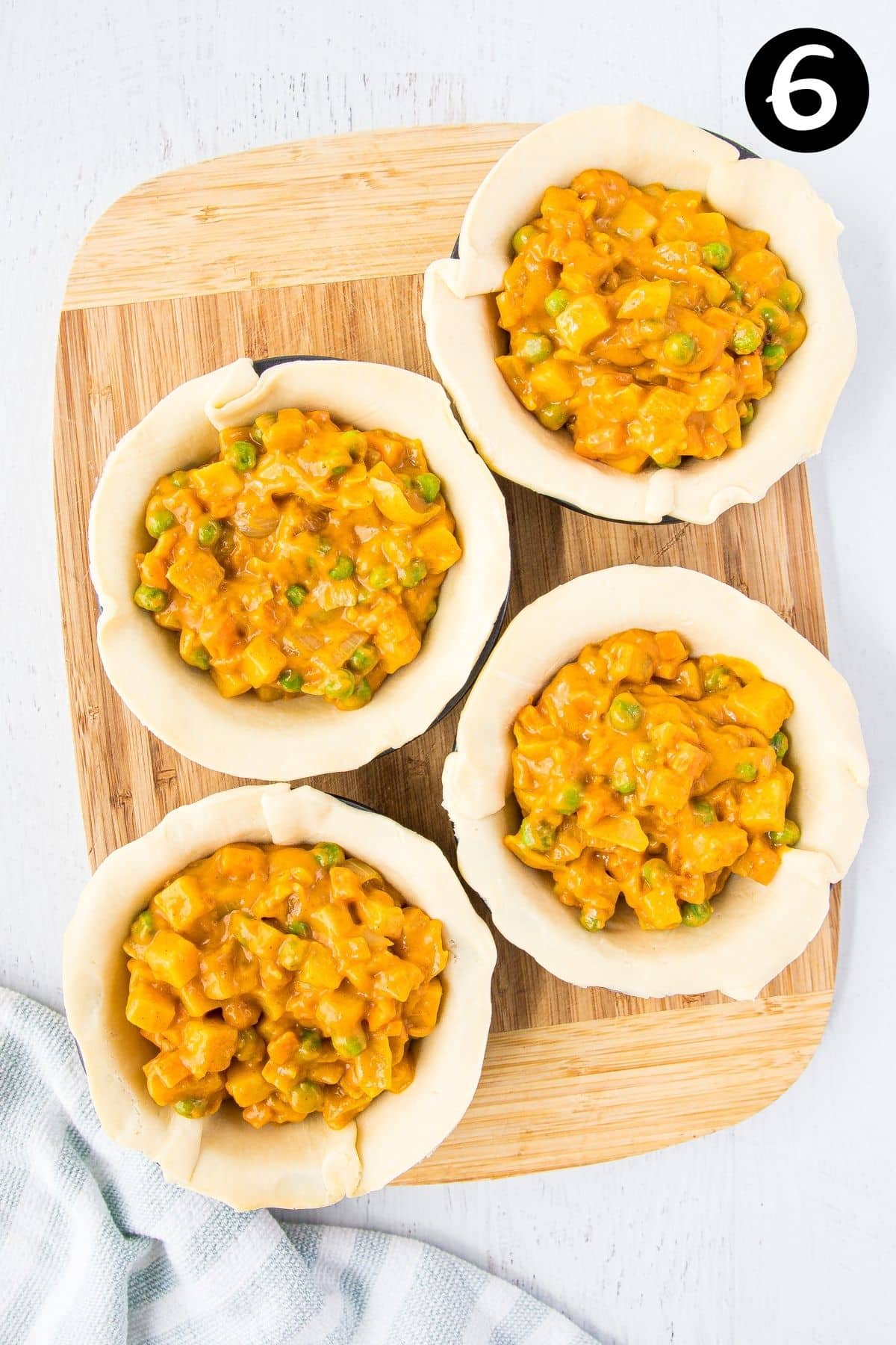 vegetable and curry filling spooned into pastry cases