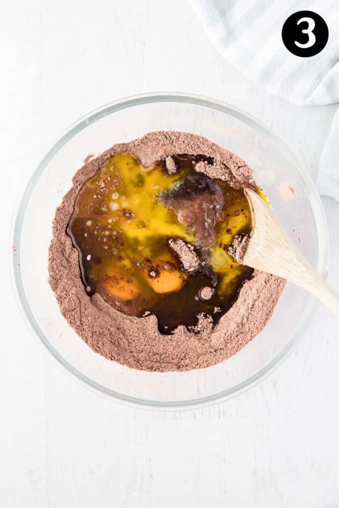 eggs and melted butter added to the dry ingredients in a glass bowl