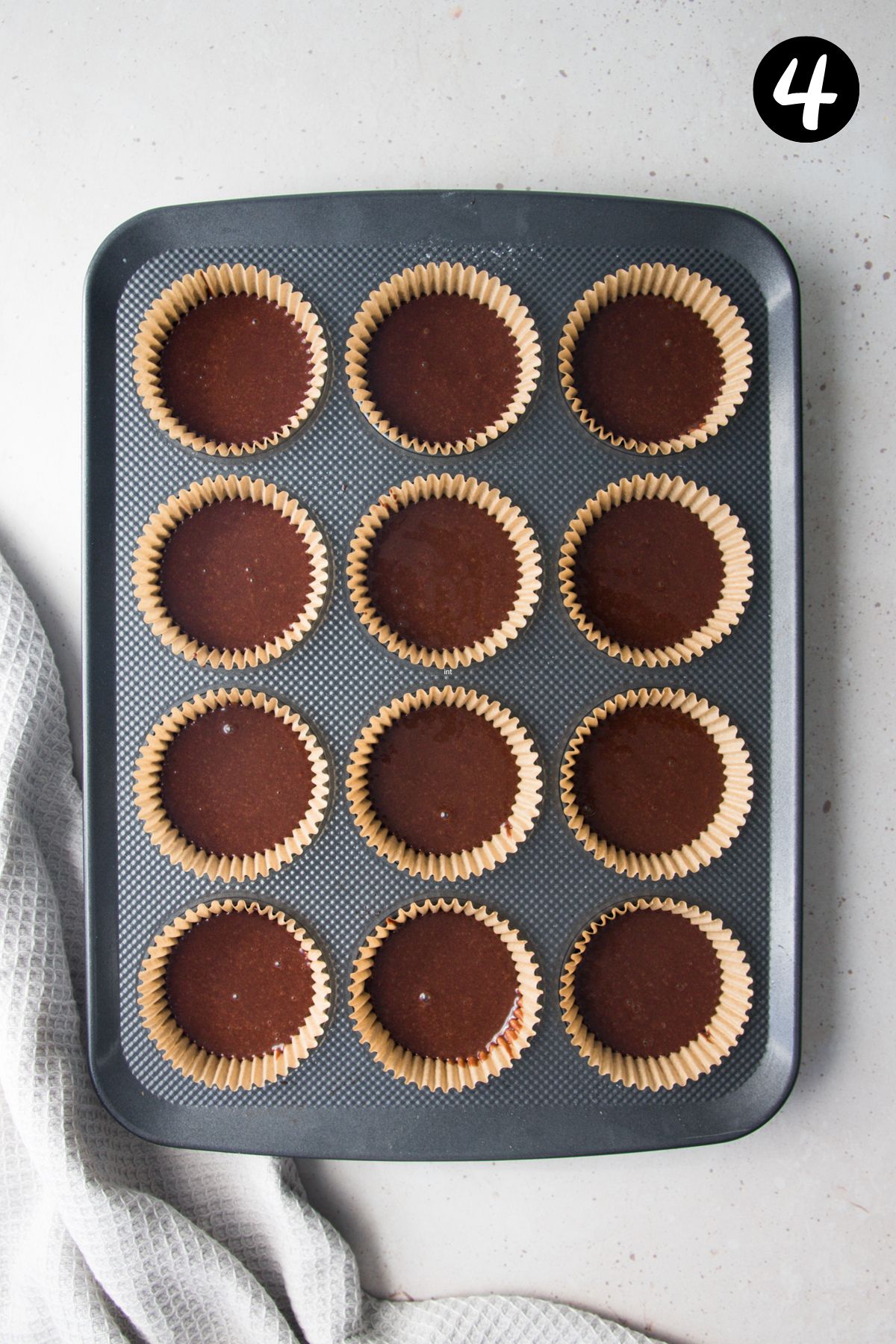 batter divided into a cupcake tray