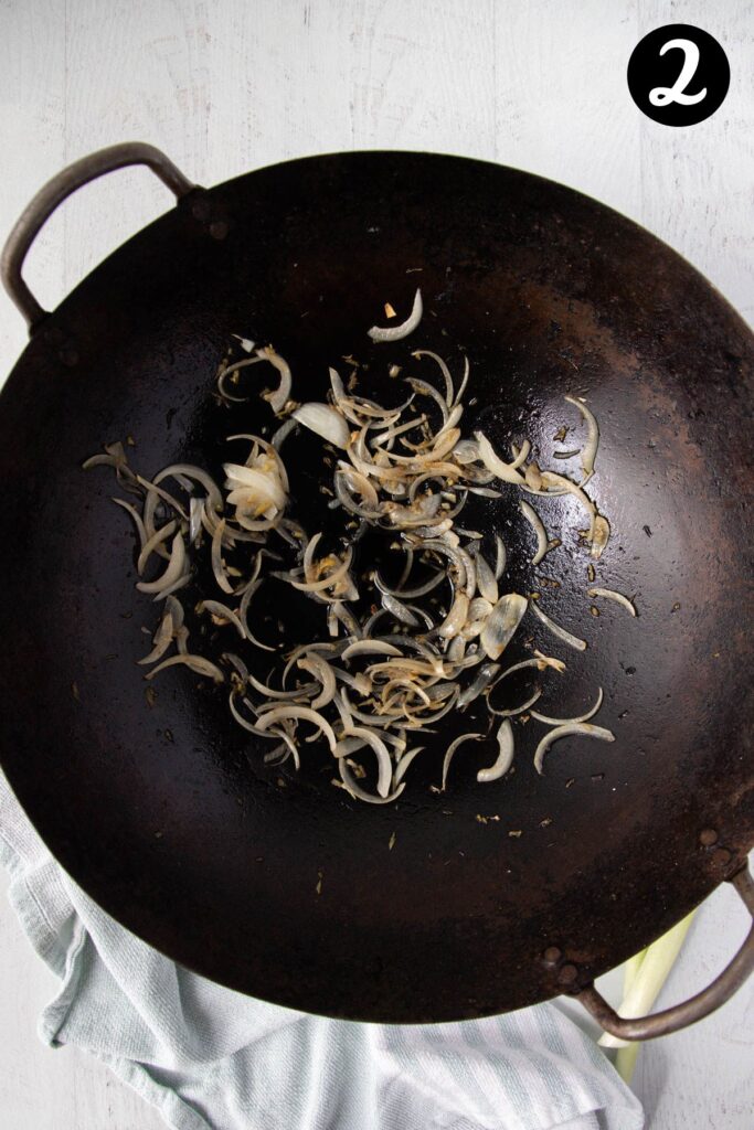 onion and ginger frying in a wok