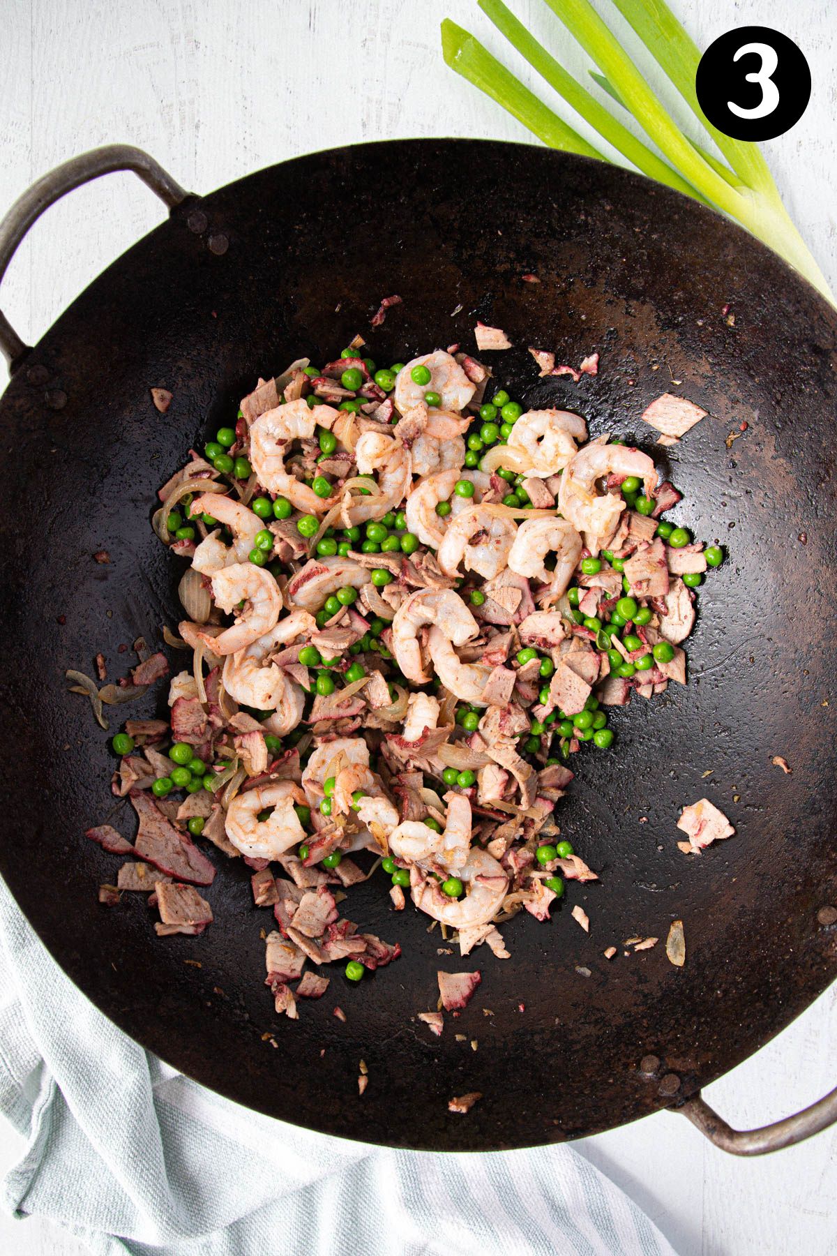 prawns, pork and peas frying in a wok