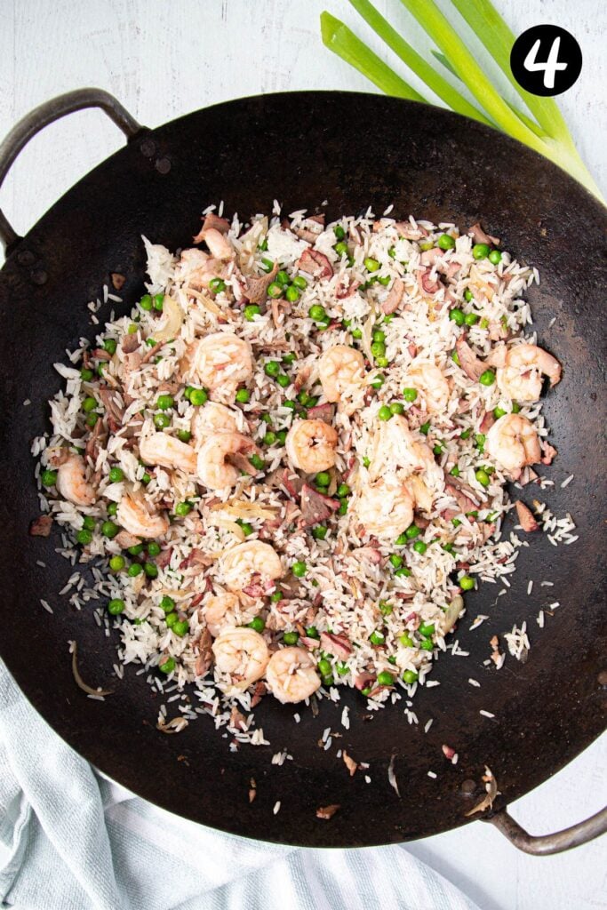 rice and prawns frying in a wok