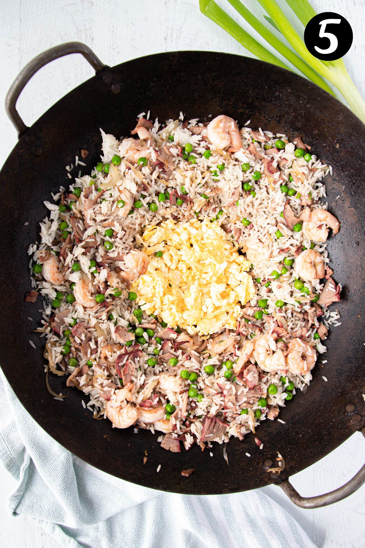 fried egg in the middle of rice in a wok