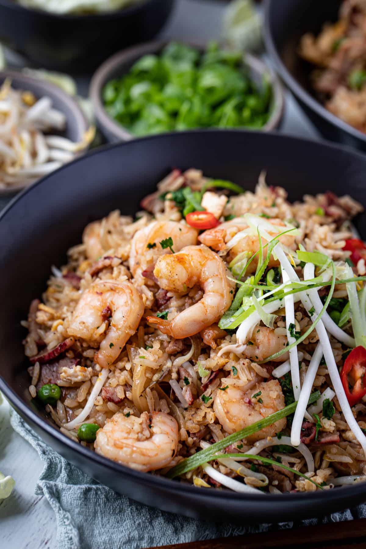 a bowl of fried rice topped with prawns and egg