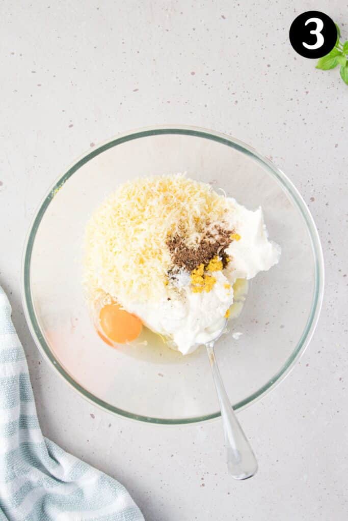 ricotta and egg in a bowl with other gnocchi ingredients.