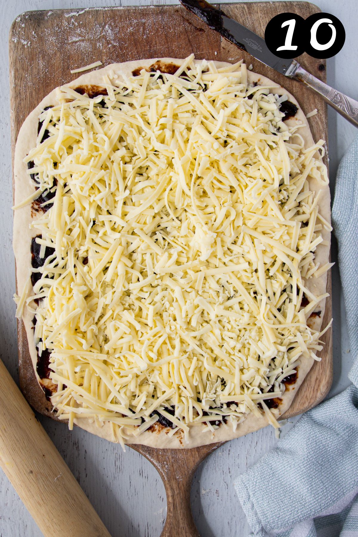 shredded cheese spread over vegemite on rolled dough.