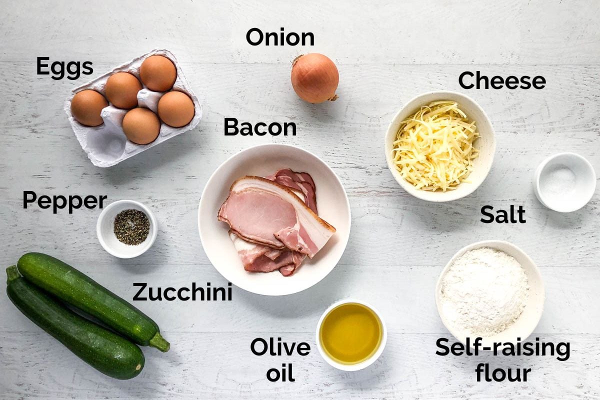 all ingredients for zucchini slice laid out on a table.