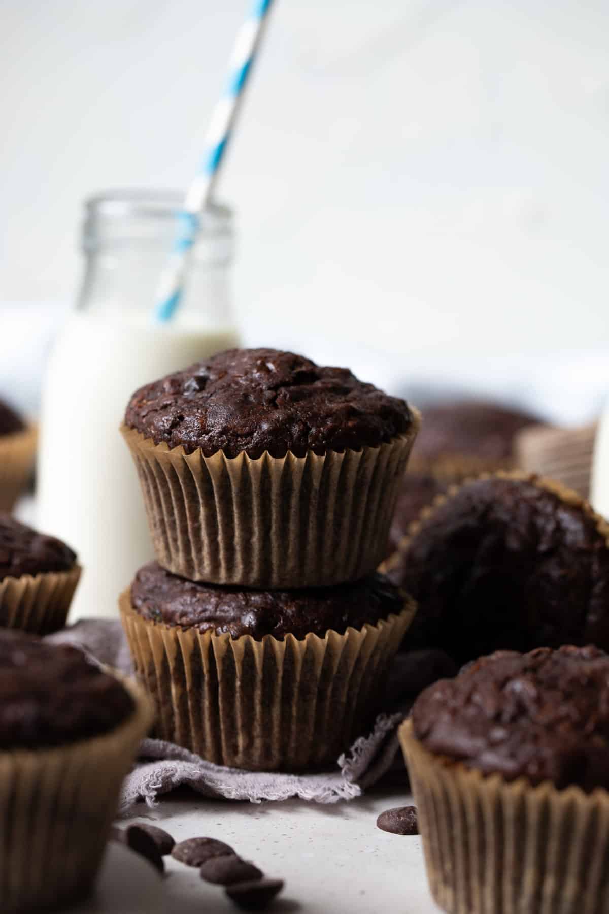 finished muffins on a table with milk and chocolate chips.