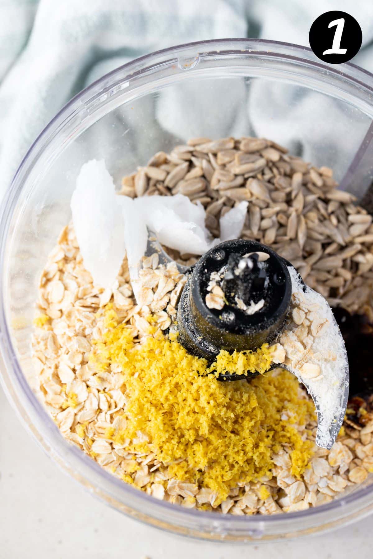 ingredients for lemon bliss balls in a food processor.