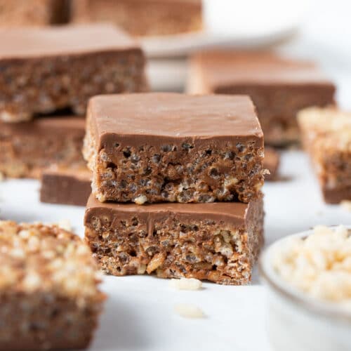 pieces of mars bar slice on a table with a bowl of rice bubbles.