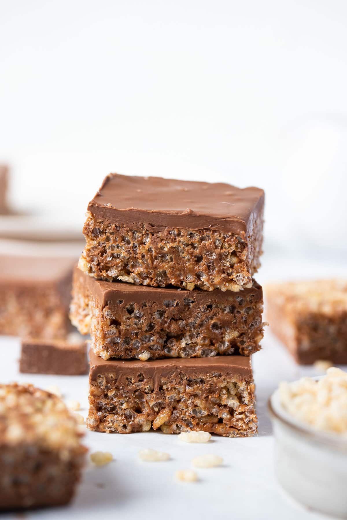 mars bar slice stacked in a pile on a white table.