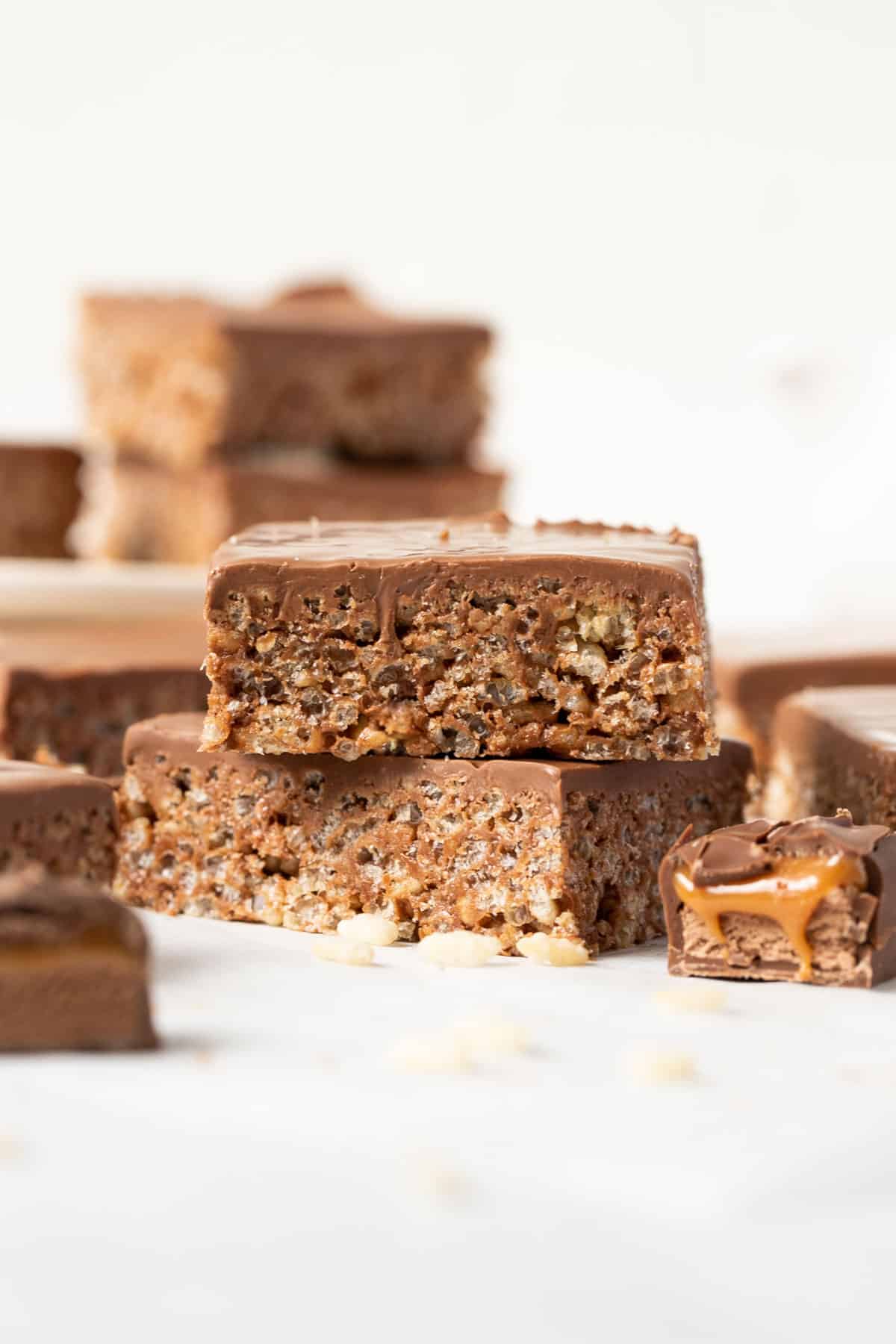 mars bar slice arranged on a white table with pieces of mars bar.