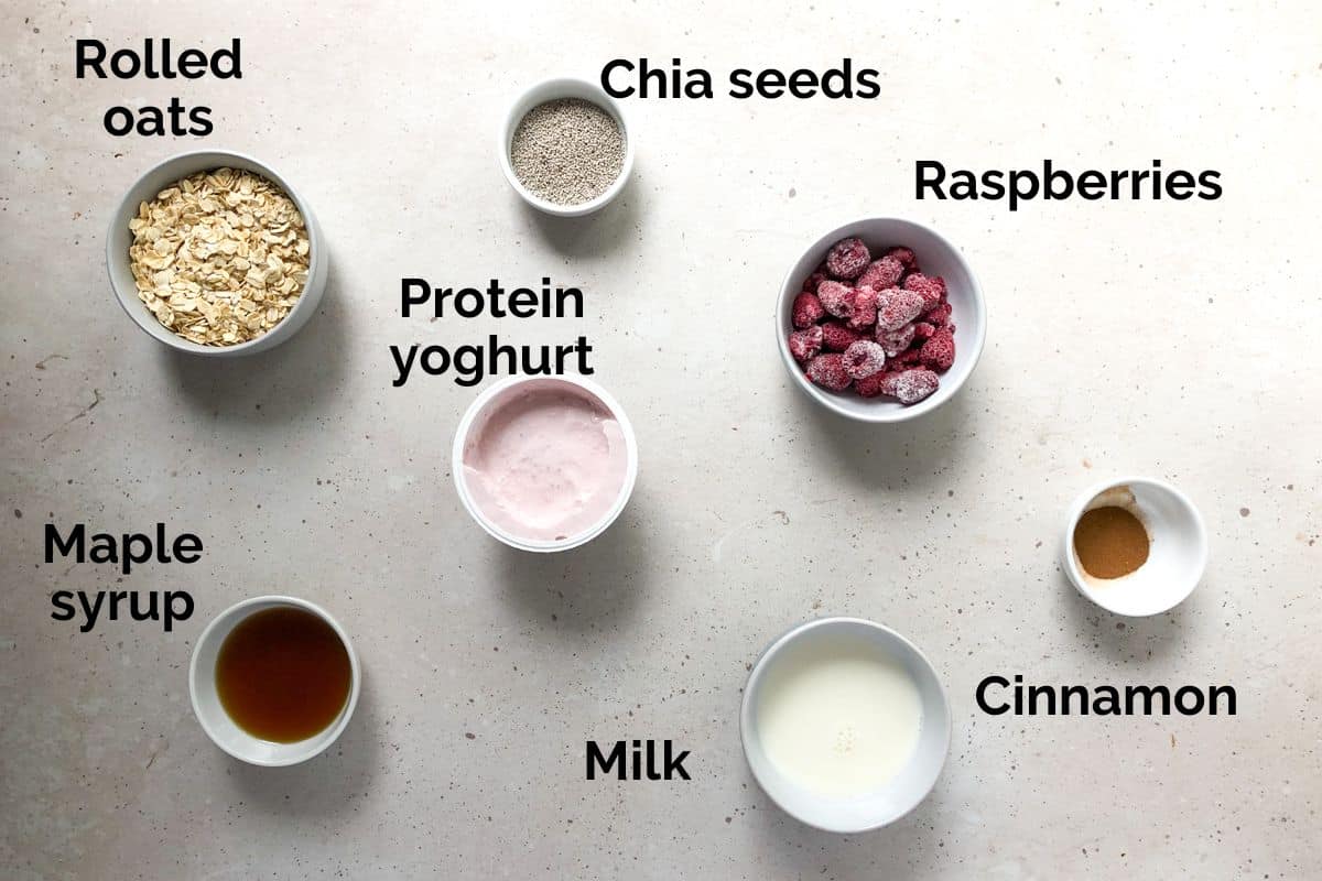 all ingredients for berry overnight oats, laid out on a table.