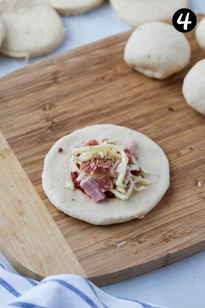 pizza toppings on a piece of round dough.