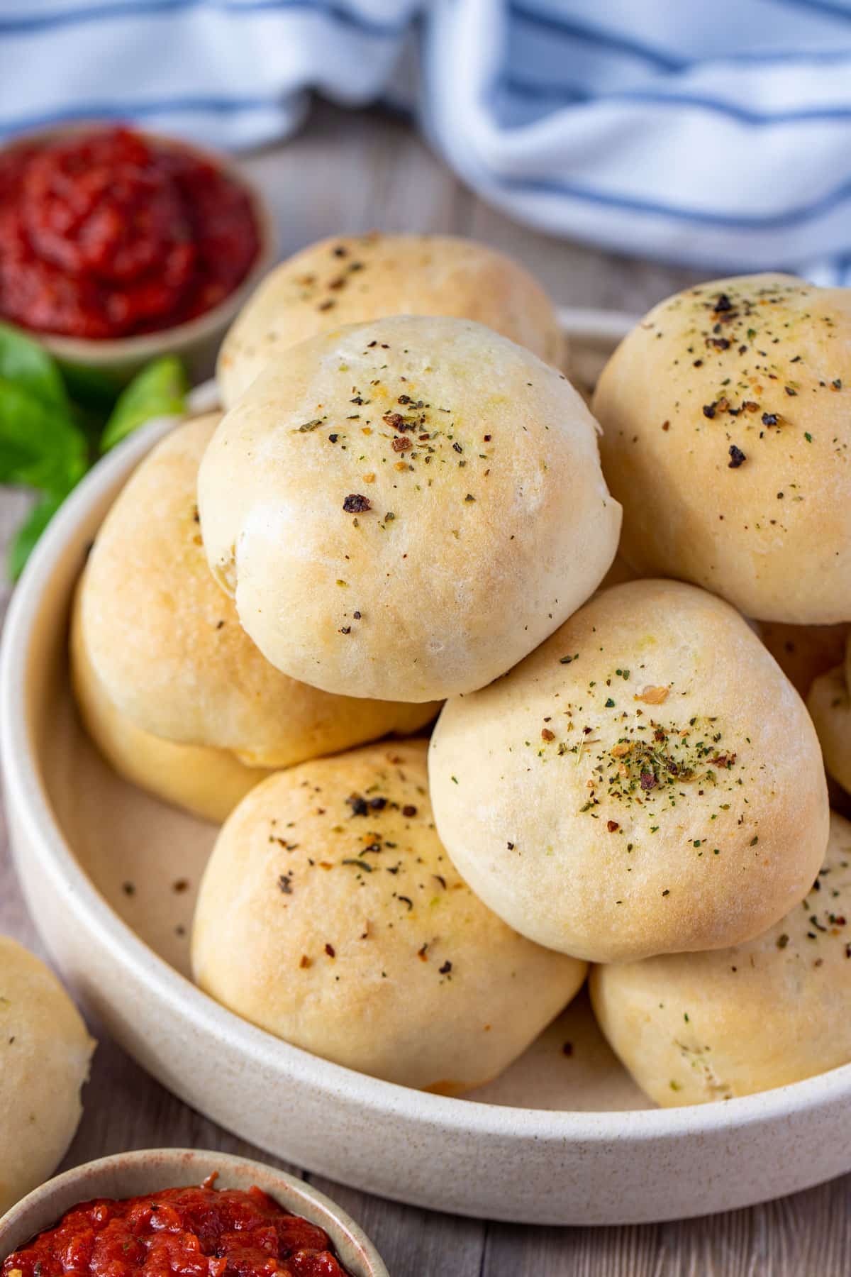 a bowl of pizza pockets topped with herbs.