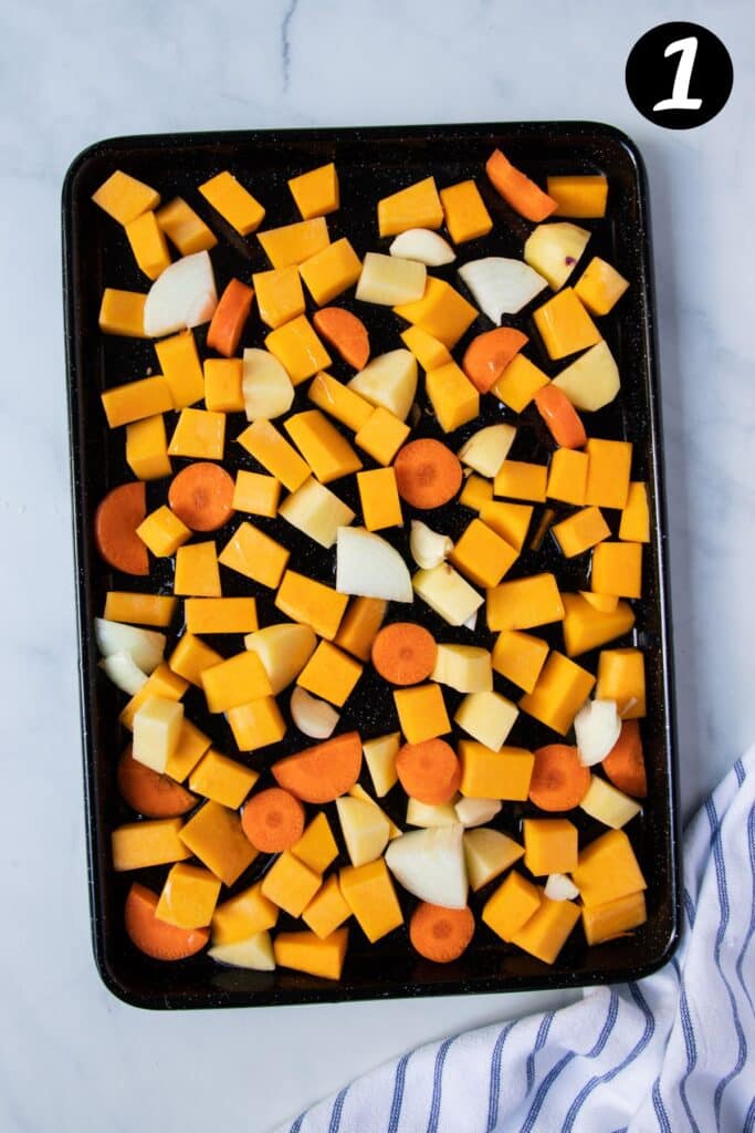 a tray of chopped vegetables, including pumpkin, carrot and potato.