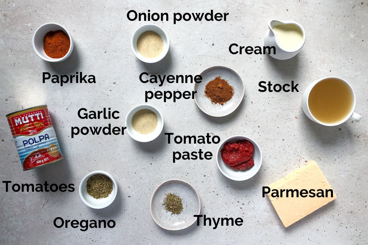 ingredients for sausage pasta, laid out on a table.