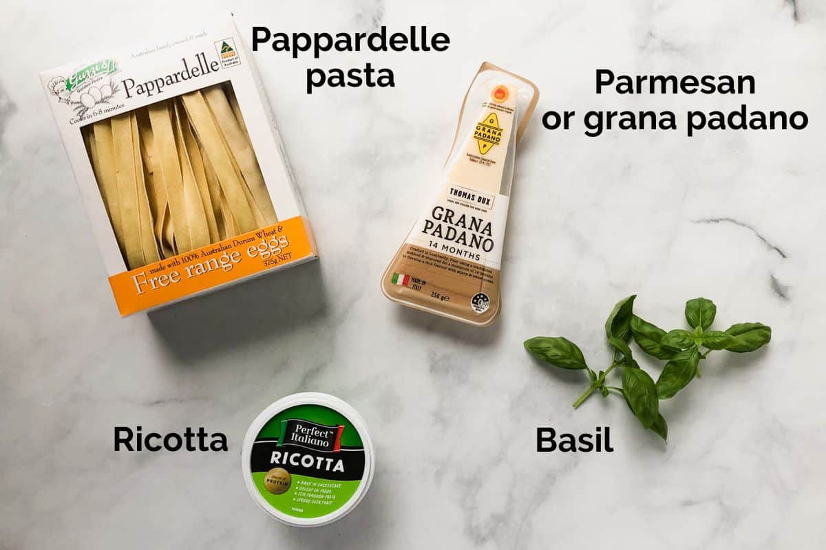 pappardelle pasta and ingredients to serve with ragu on a table.