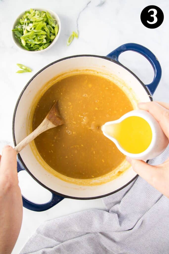 egg whites being poured into a pot of soup,