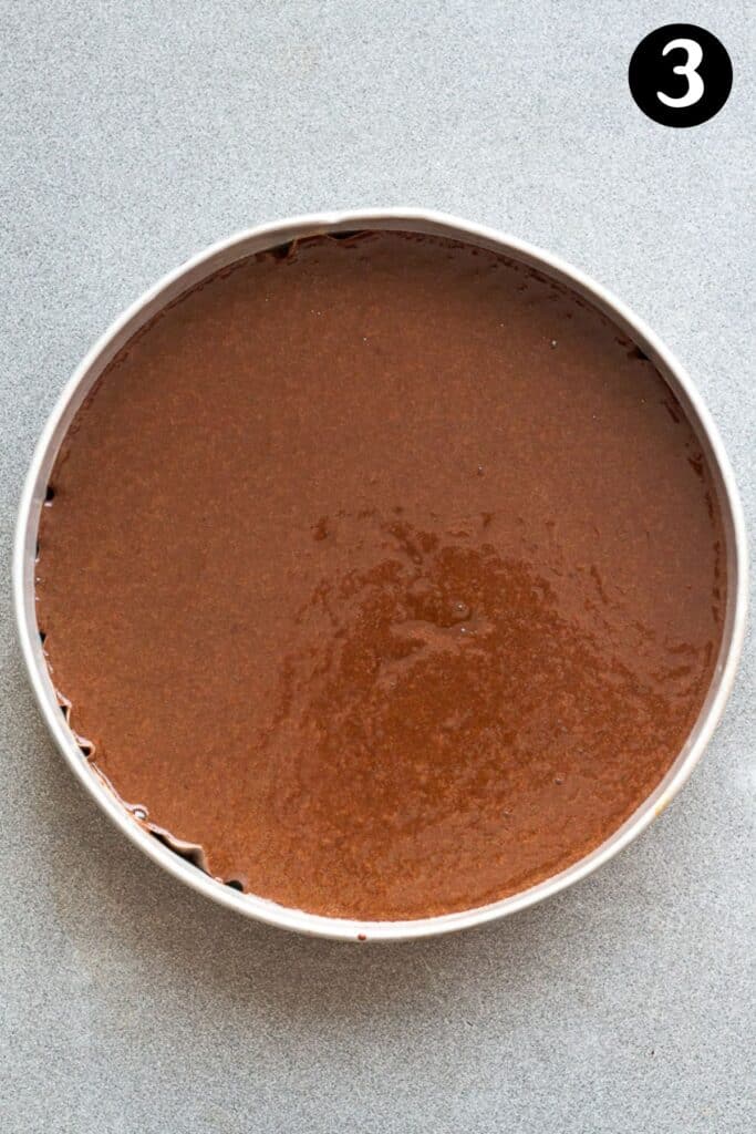 cake batter in a lined cake tin.