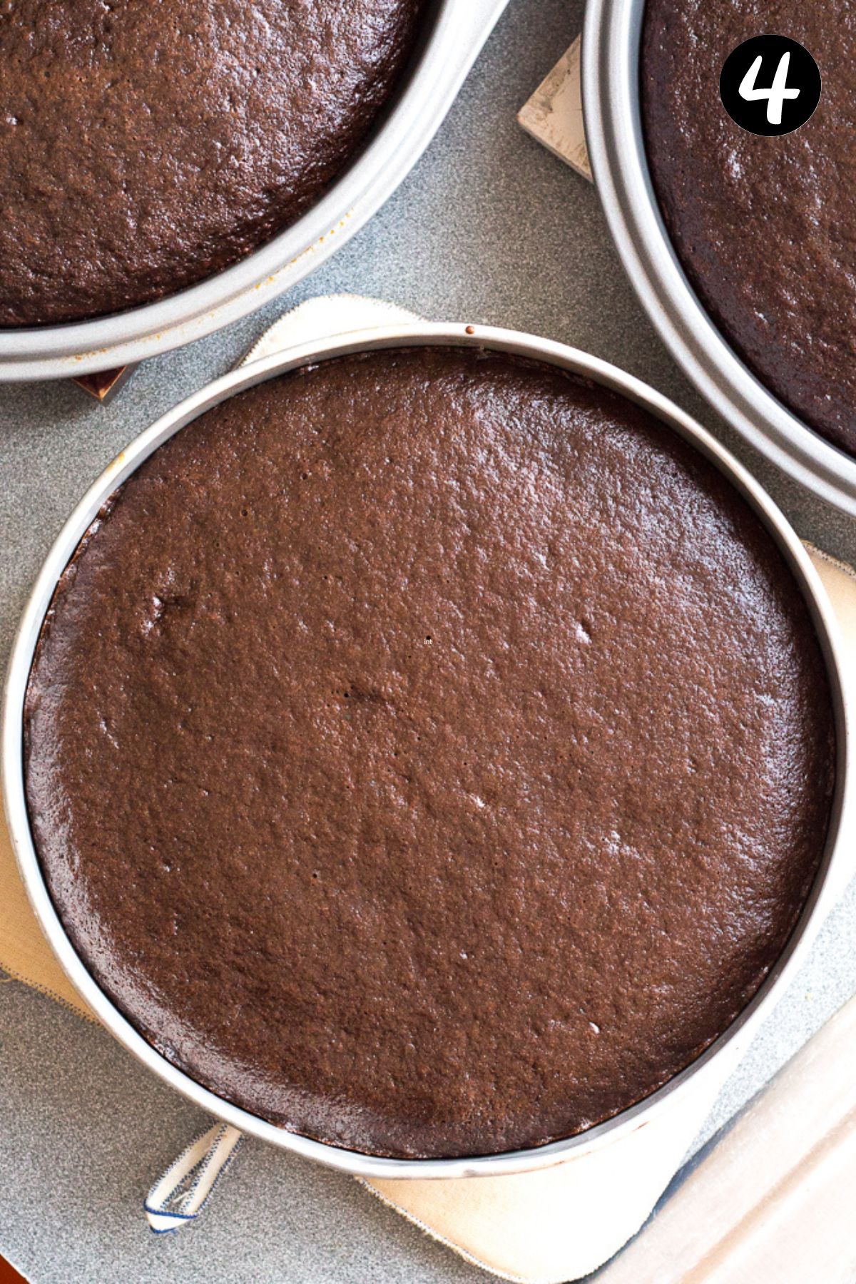finished chocolate cakes in cake tins.