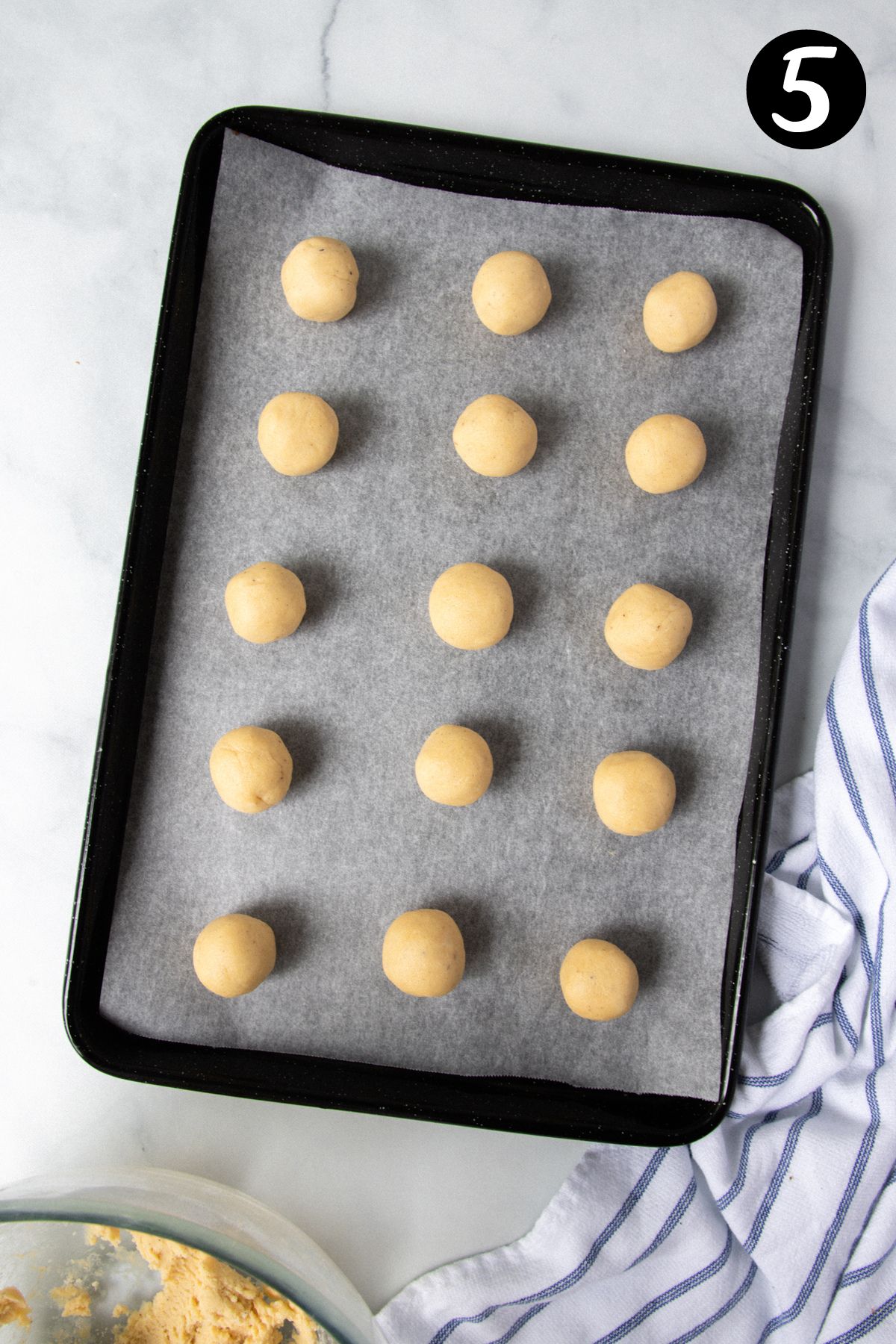 balls of dough on a tray lined with baking paper