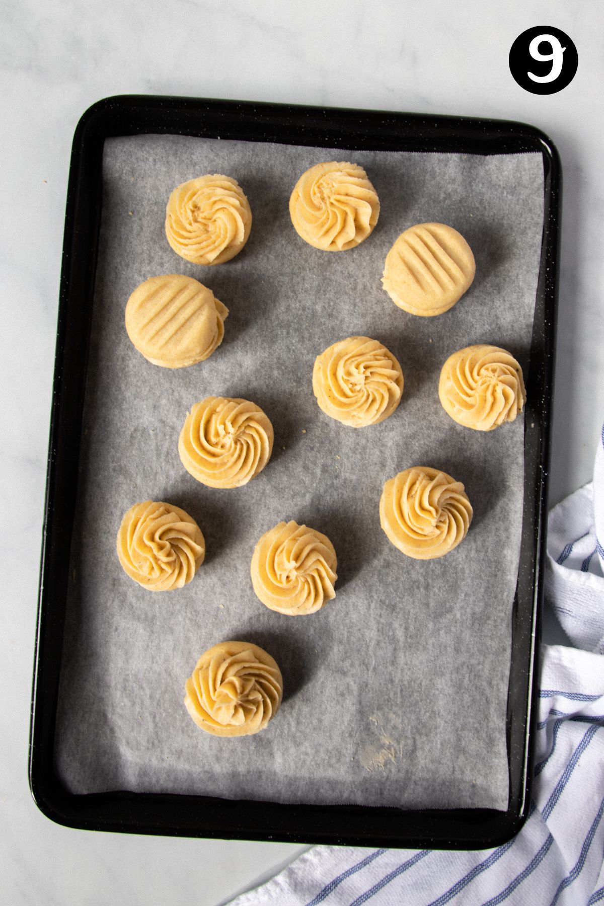 melting moments on a baking tray, topped with piped buttercream.