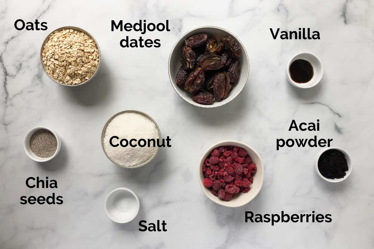 all ingredients for raspberry bliss balls laid out on a table.