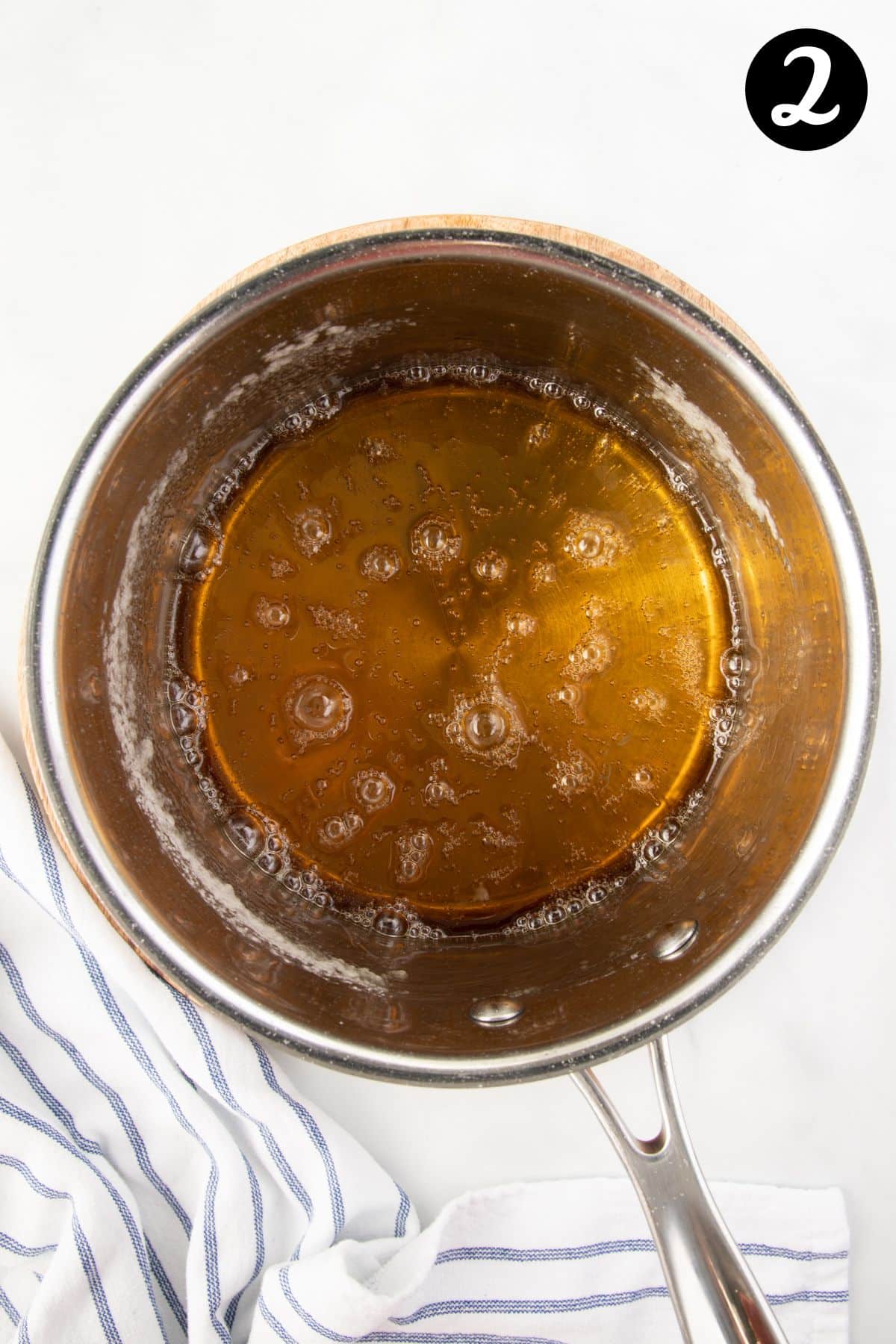 caramelised sugar syrup in a pan. It is a light amber colour.