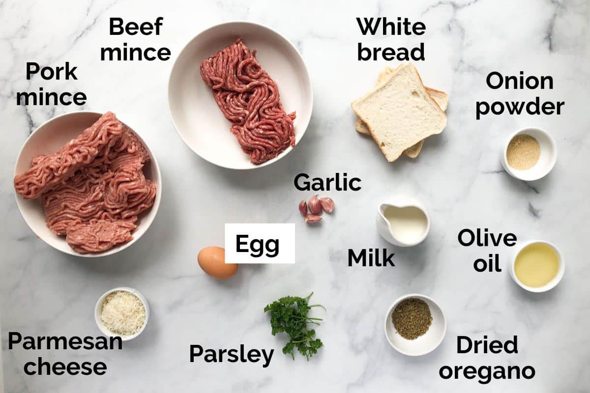 all ingredients for baked meatballs, laid out on a table.