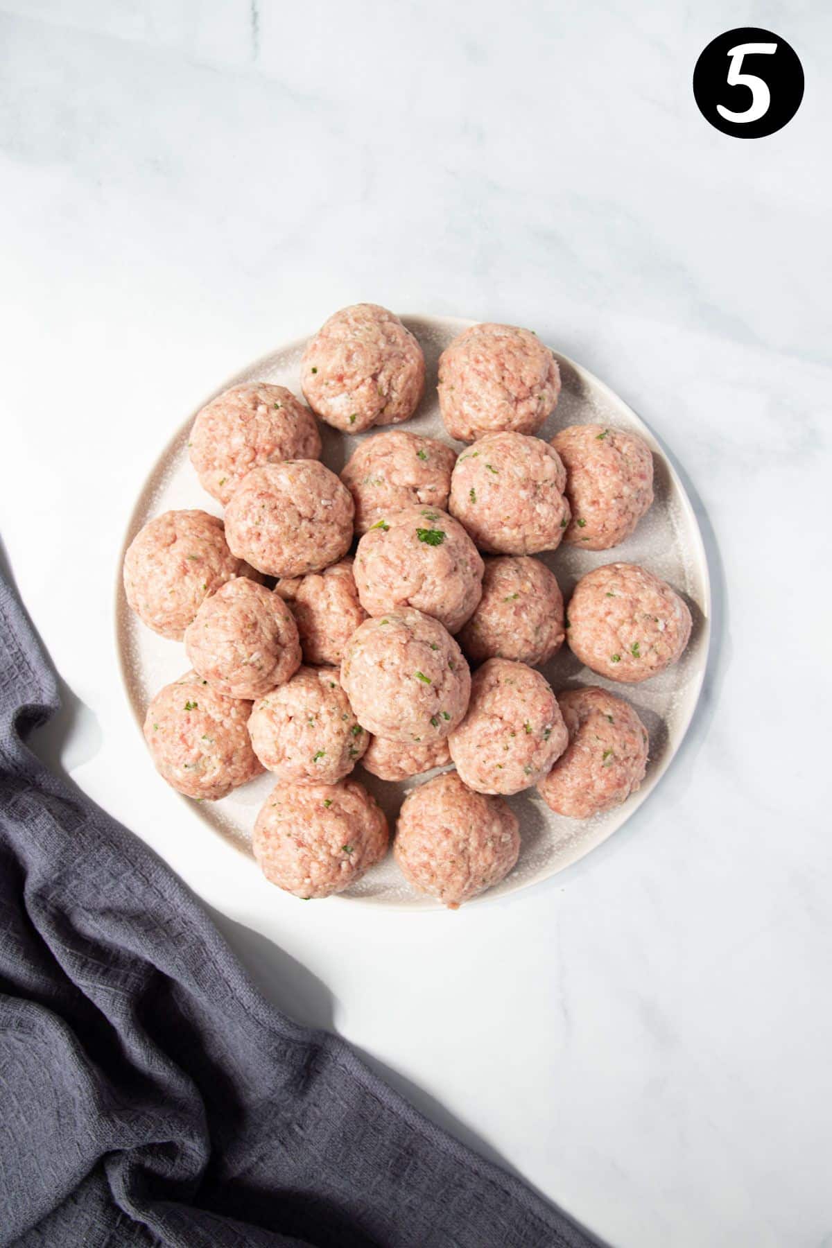 raw meatballs on a plate.