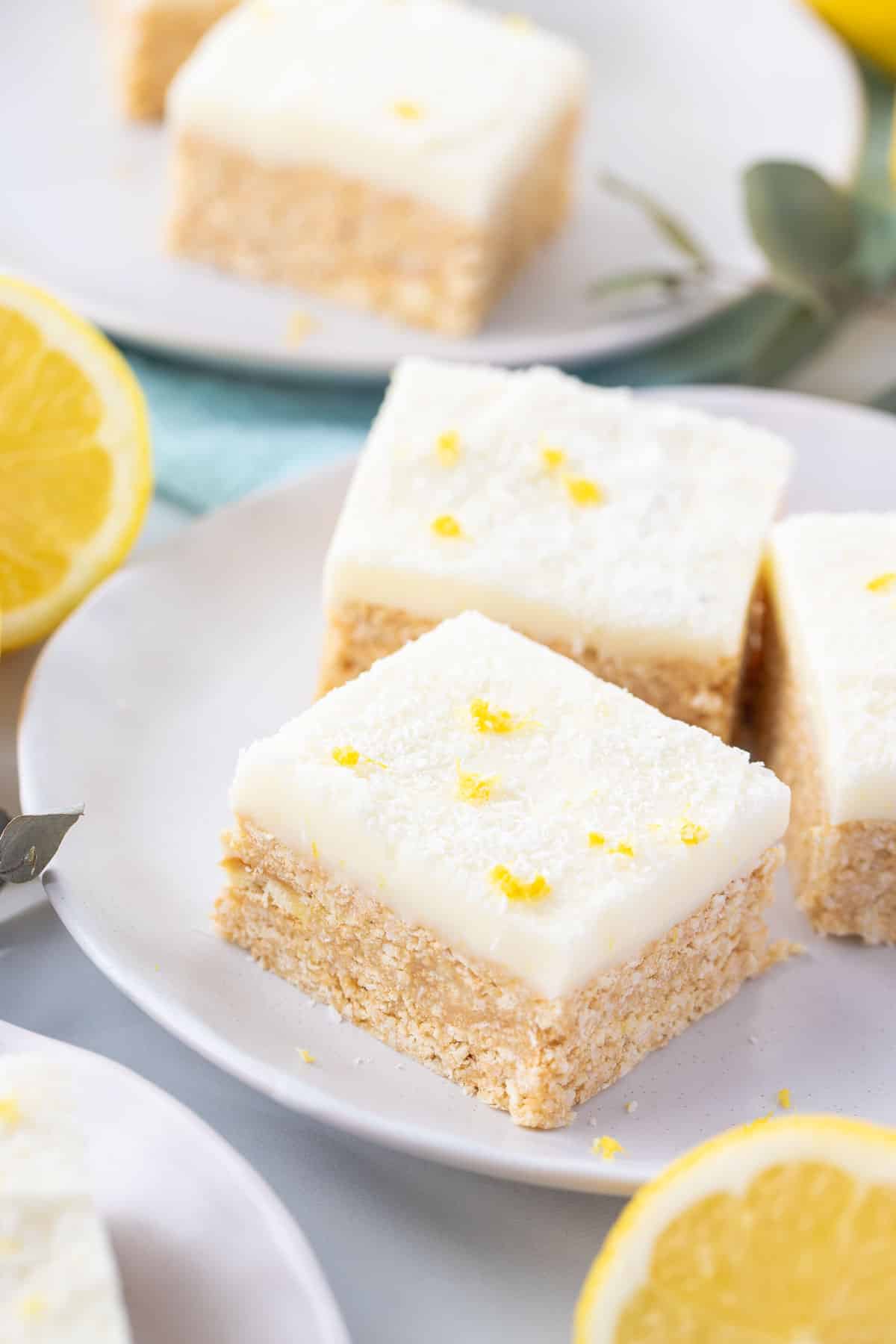 lemon slice on a plate with lemon halves and zest.