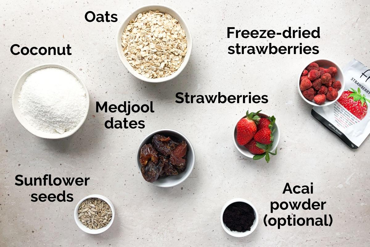 all ingredients for strawberry bliss balls, laid out on a table.