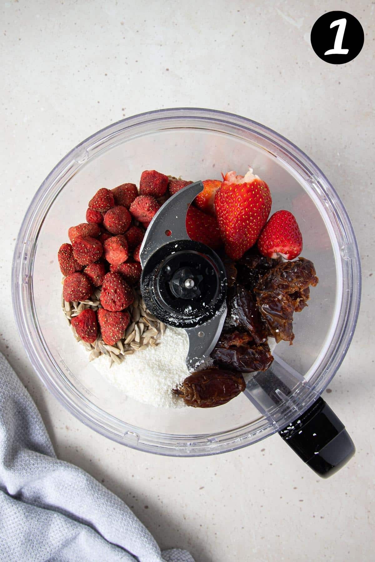 strawberries and dates with other ingredients in a food processor.
