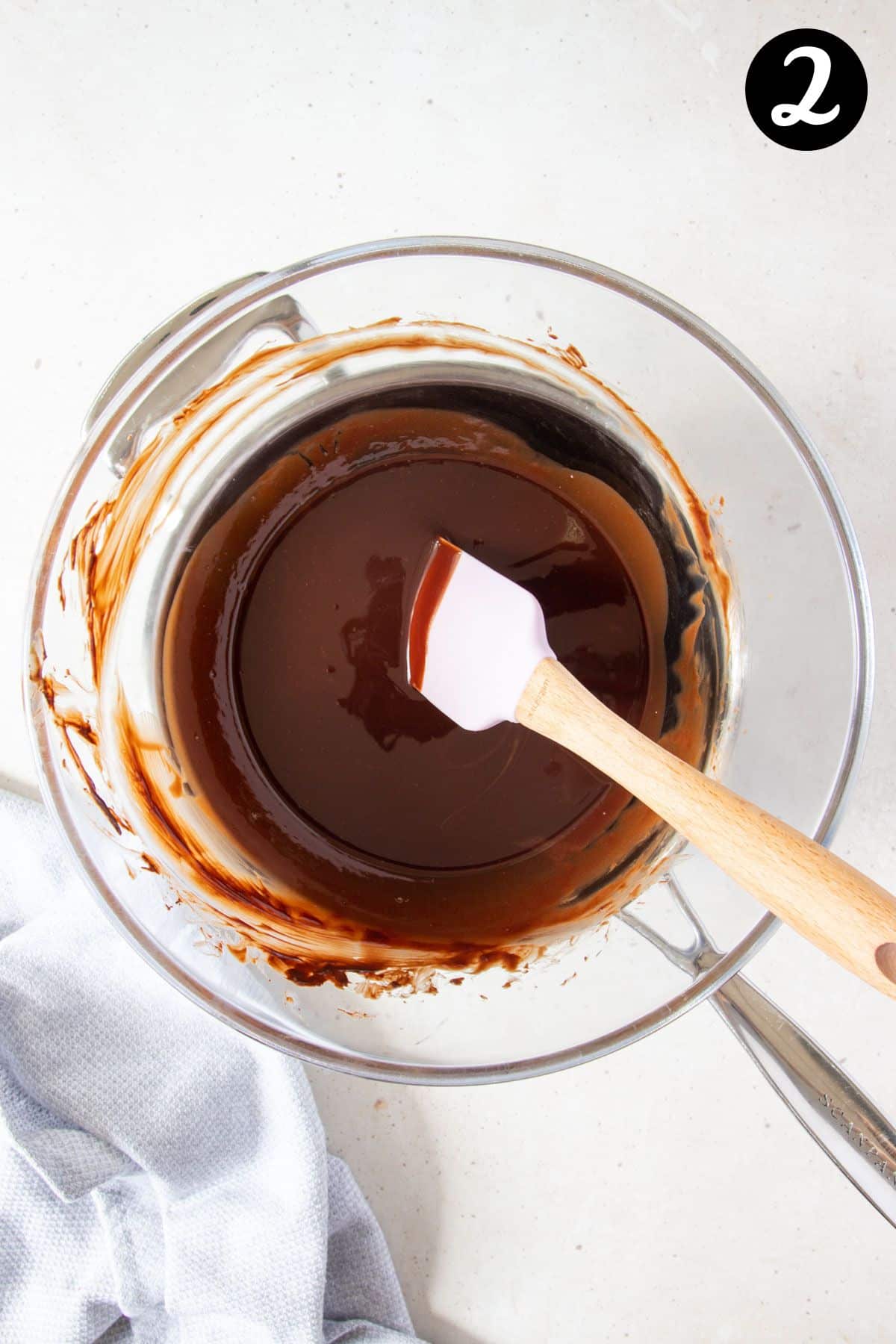 melted chocolate and butter mixture in a bowl over a saucepan.