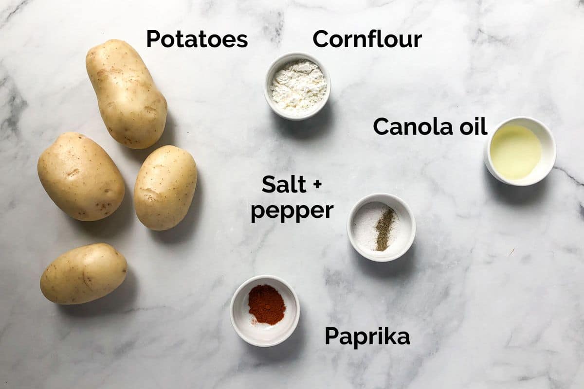 all ingredients for air fryer chips, laid out on a table.