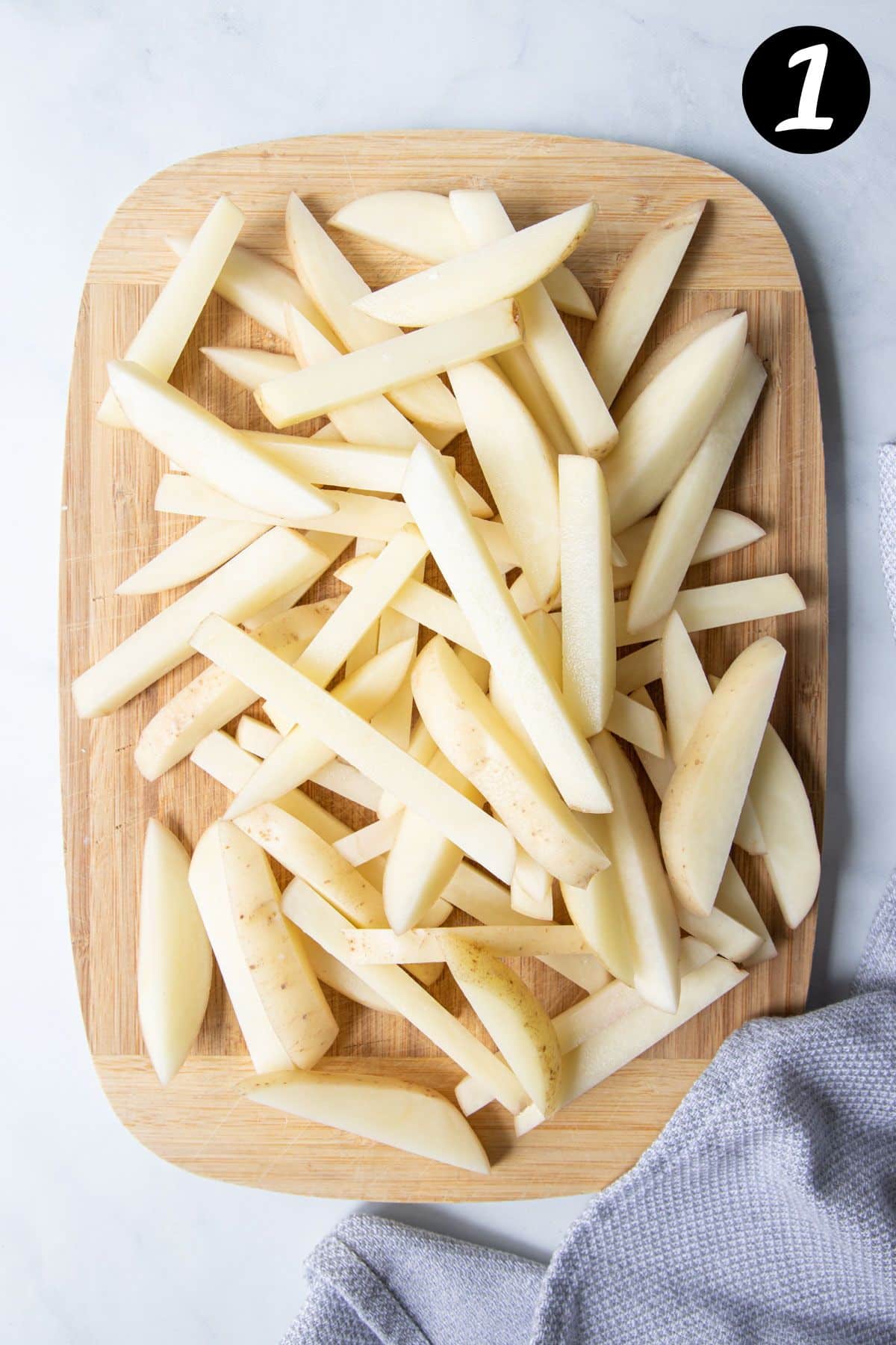 sliced potato chips on a wooden board.