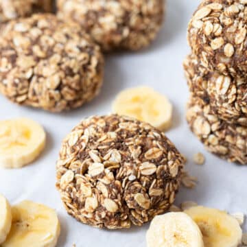 banana oat cookies on a table with slices of banana.