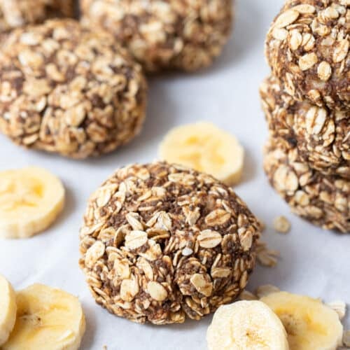 banana oat cookies on a table with slices of banana.