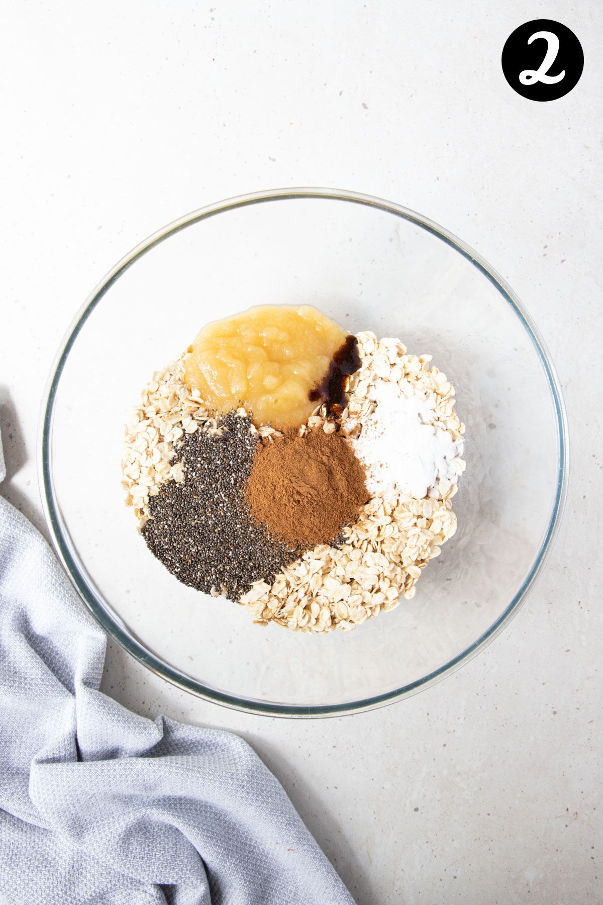 mashed banana, oats and other ingredients in a mixing bowl.
