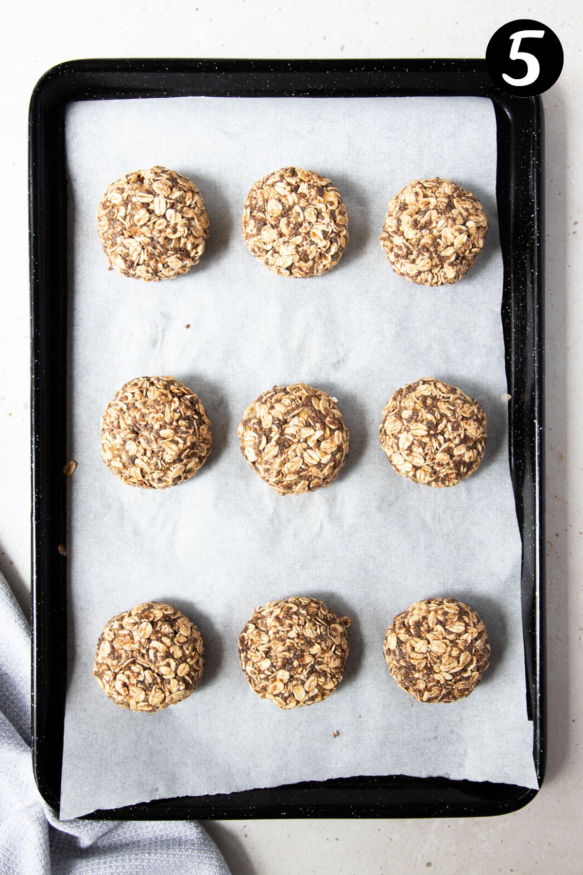 oat cookies on a baking tray lined with paper.