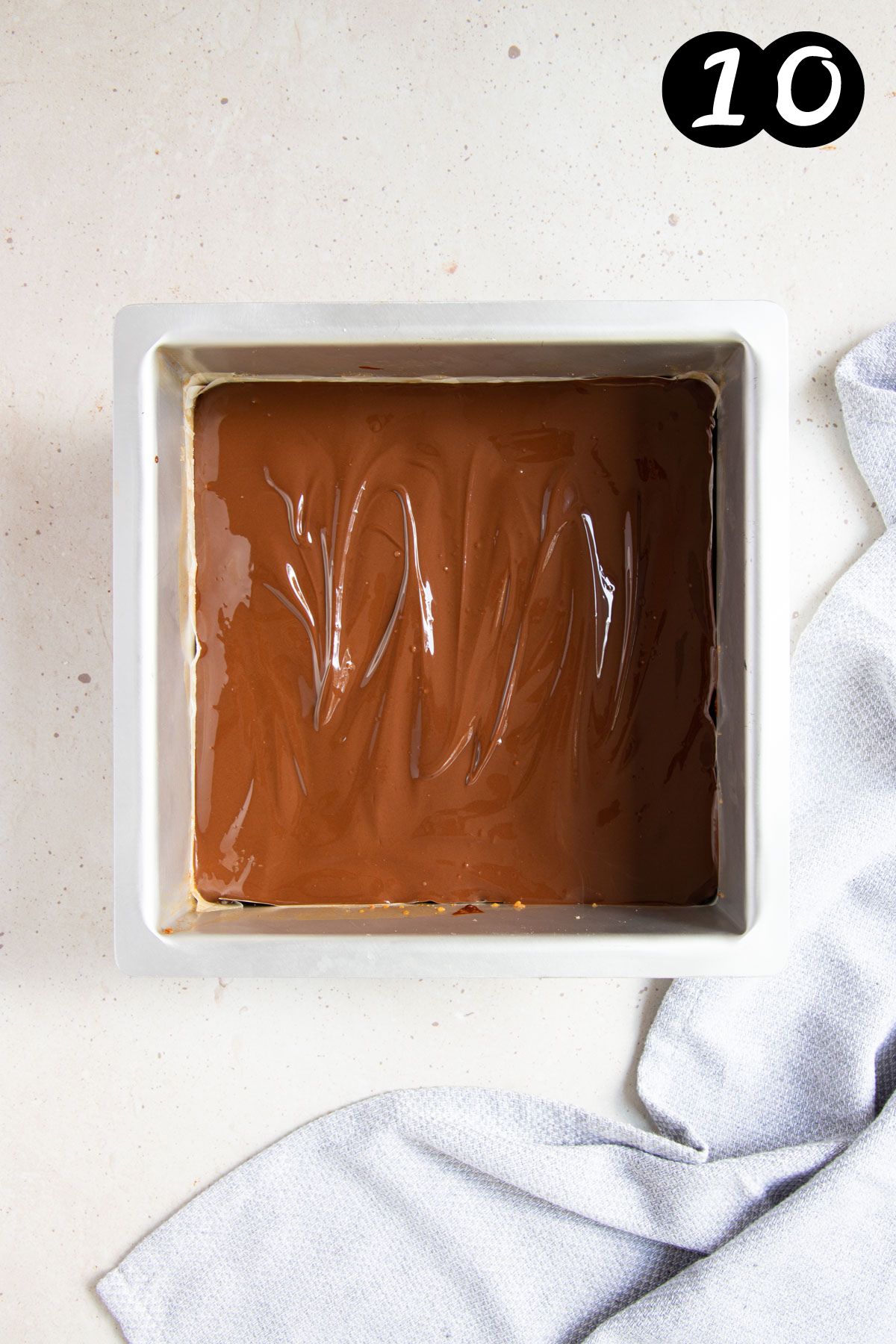 a square baking tin with melted chocolate.
