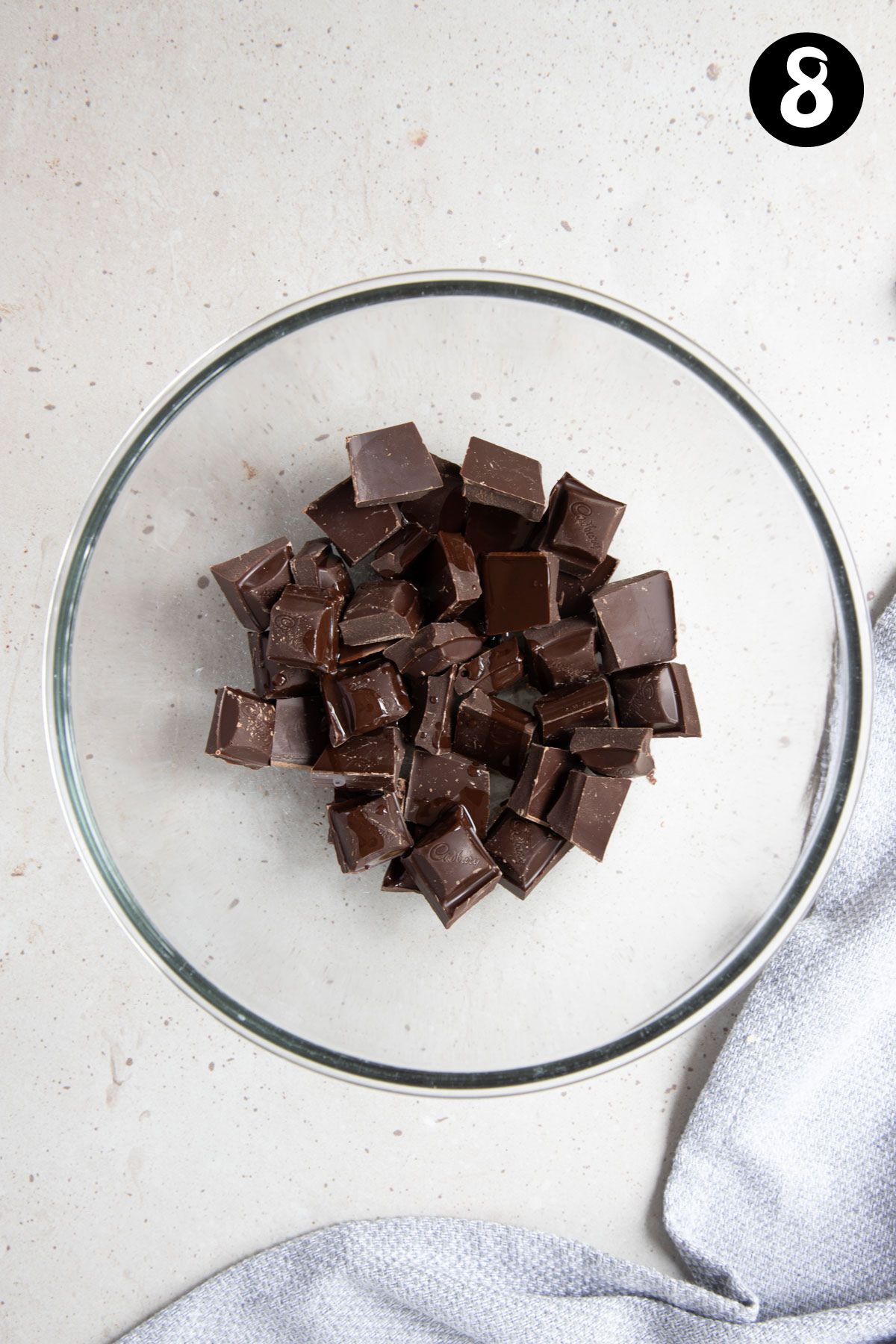 chocolate pieces and oil in a glass bowl.