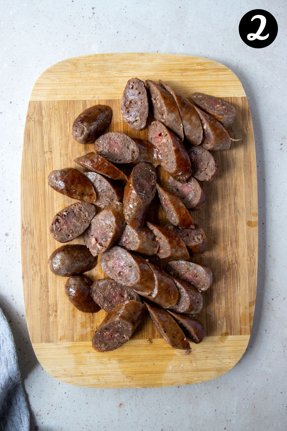 sliced sausages on a wooden board.