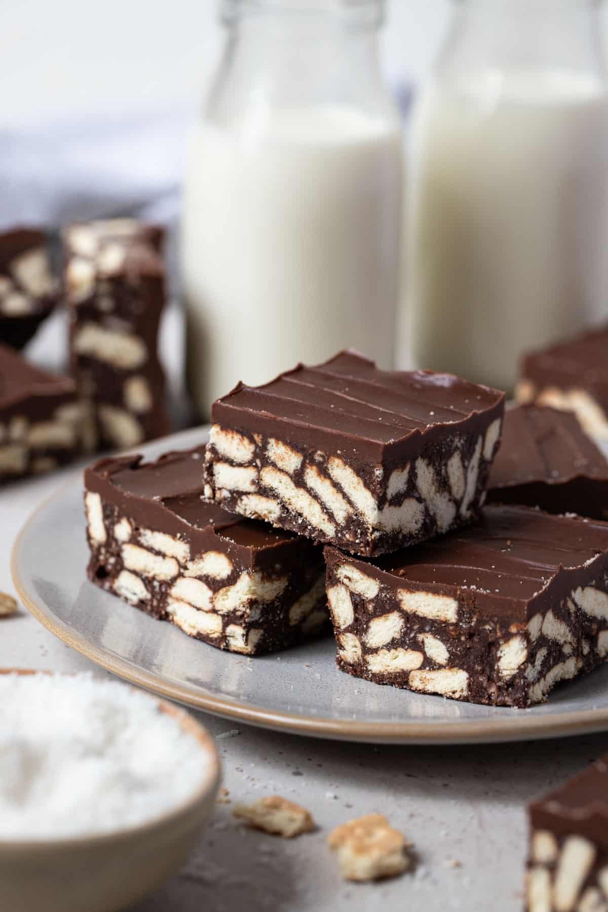 pieces of hedgehog slice topped with chocolate on a plate.