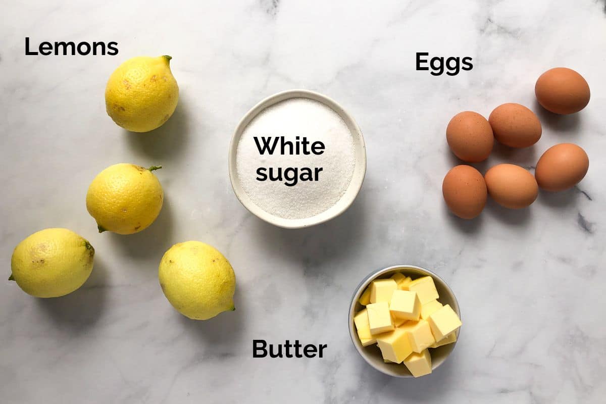 all ingredients for lemon curd laid out on a table.