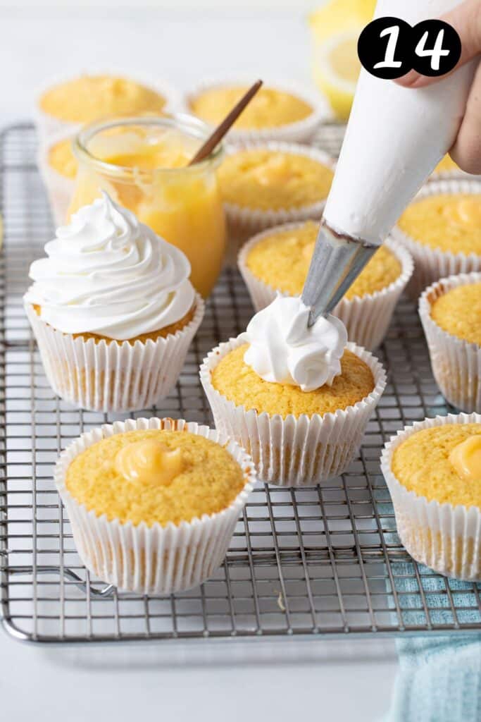 a piping bag piping meringue over the top of a cupcake.