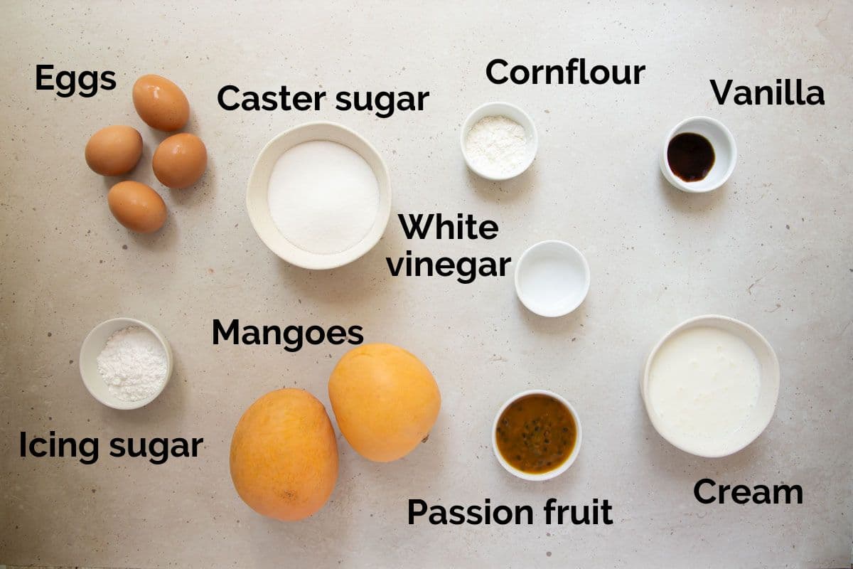 all ingredients for mango pavlova, laid out on a table.