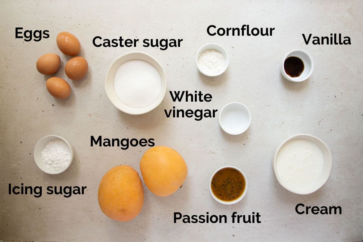 all ingredients for mango pavlova, laid out on a table.