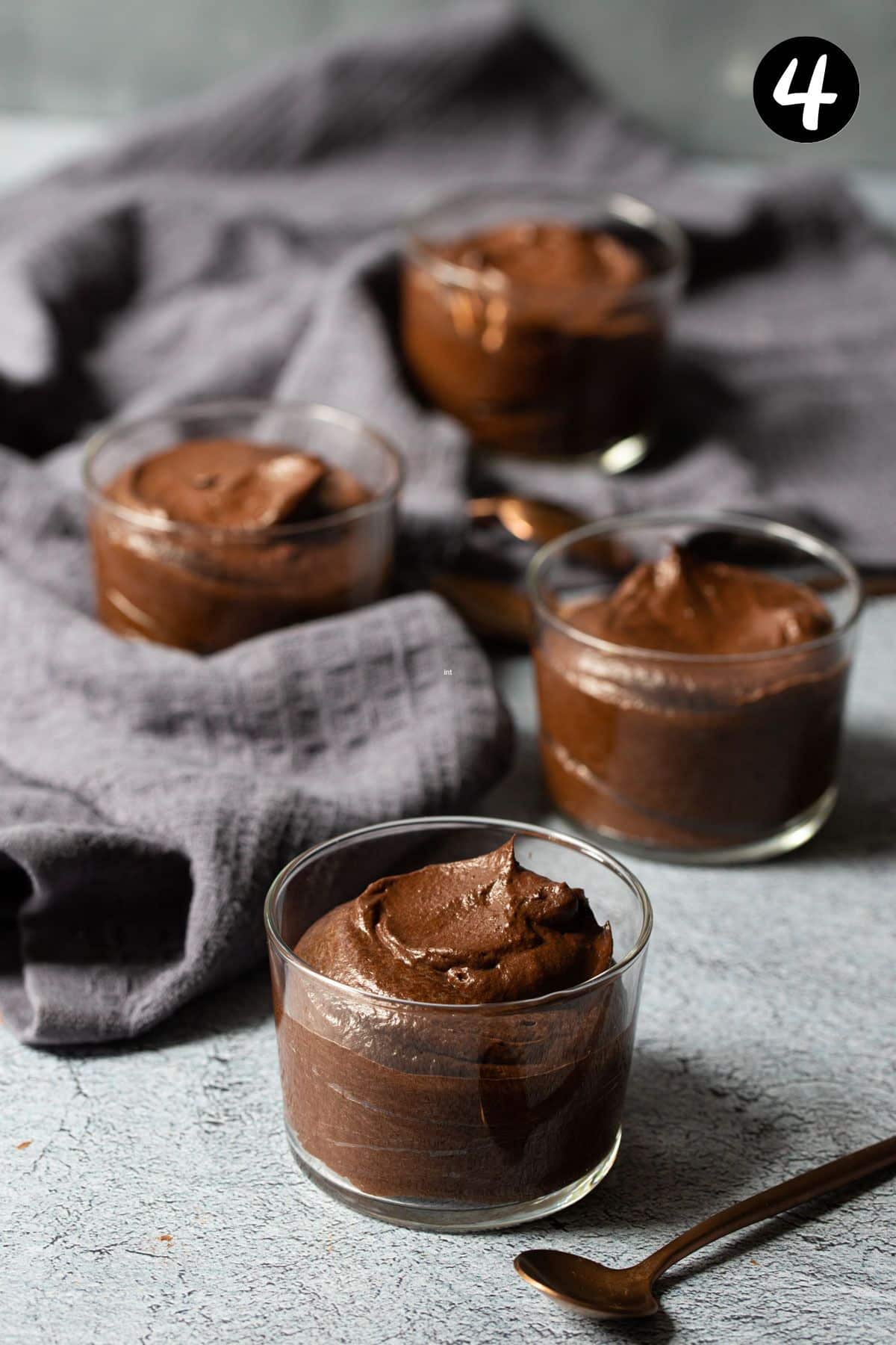 avocado chocolate mousse in individual glasses, on a table.